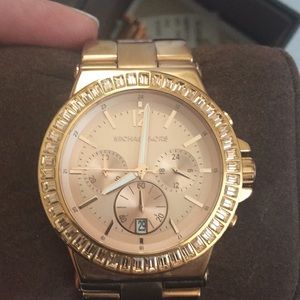 MK women’s rose gold watch.